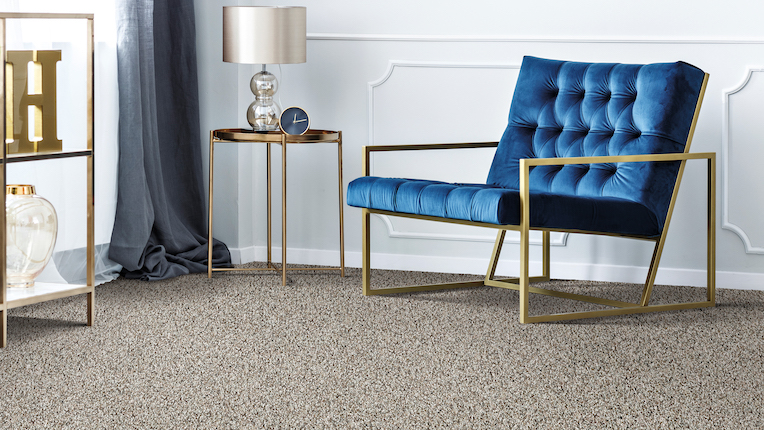 soft carpets in a living room with velvet blue chair